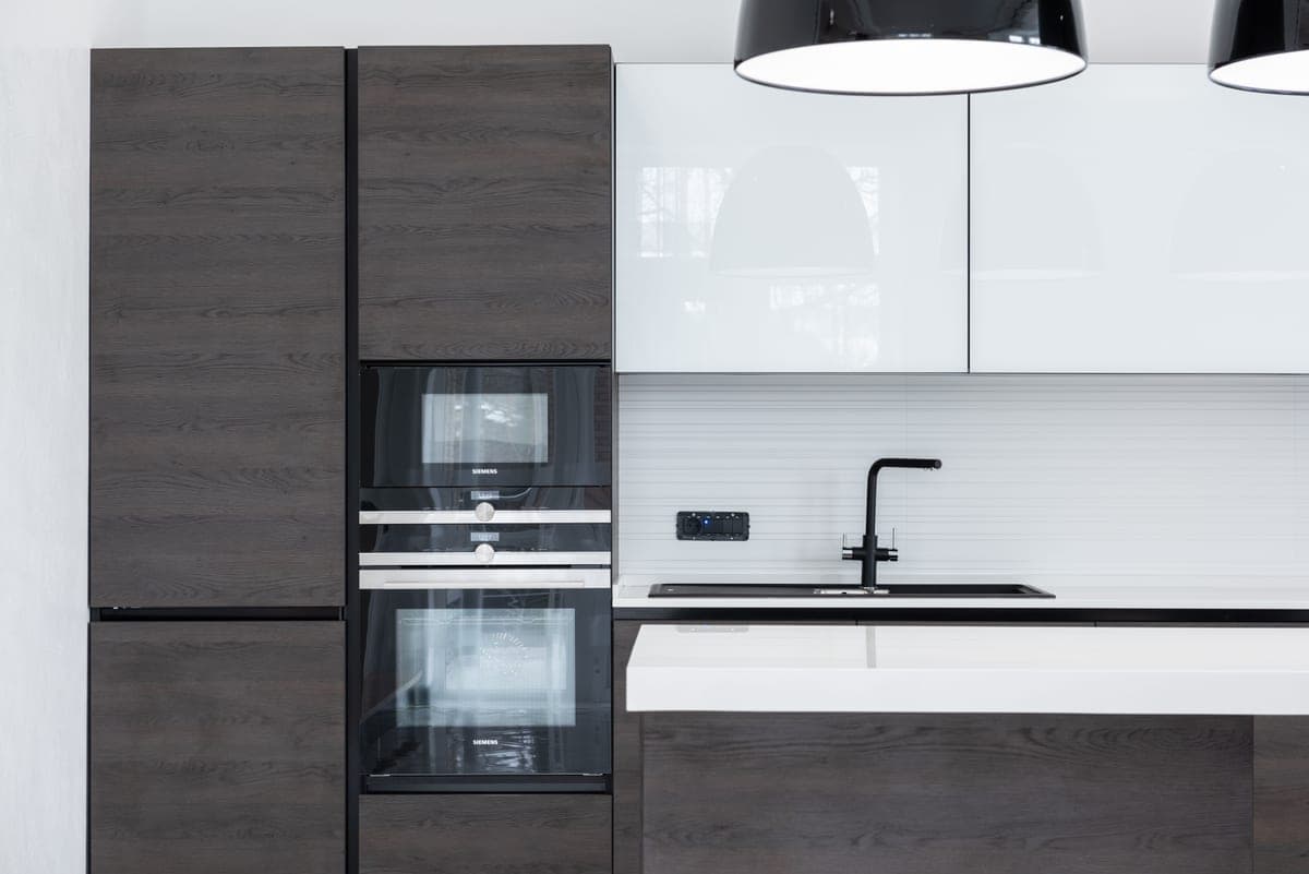 A modern kitchen interior with pale cabinets and a clear run of worktop.