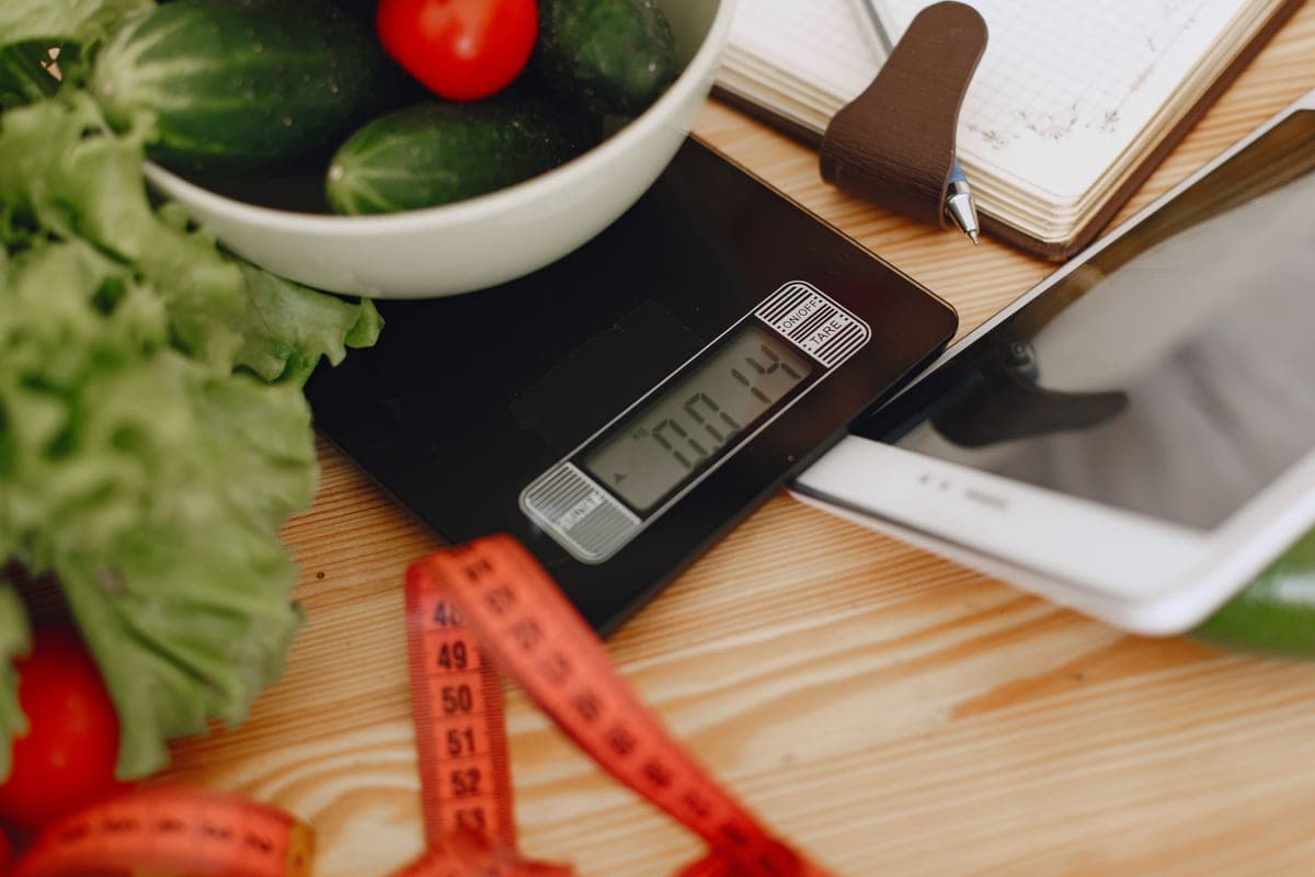 Vegetables in a bowl resting on a kitchen scale.